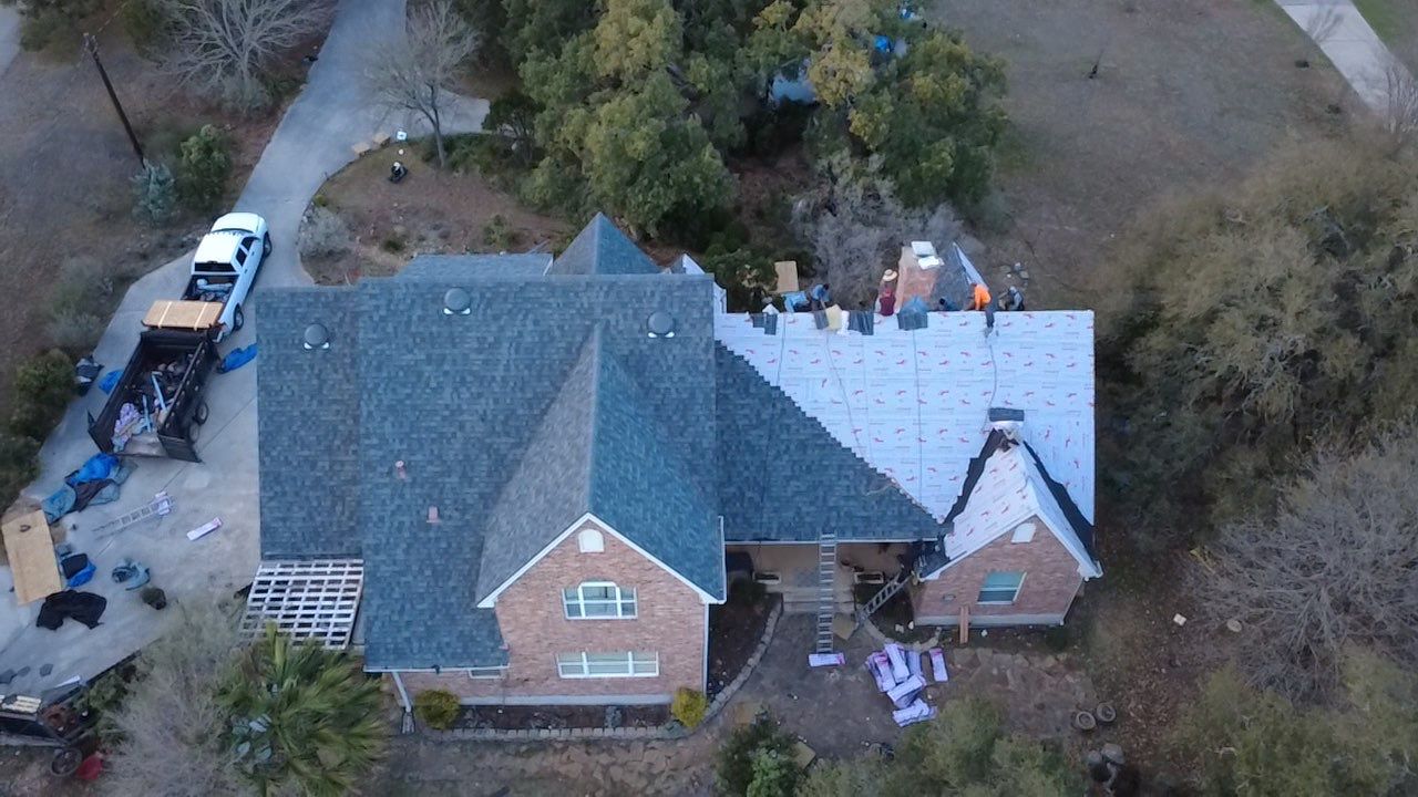Central Texas residential roof replacement in progress - crew working