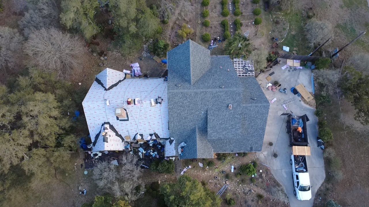 New roof installation showing underlayment and decking - aerial view