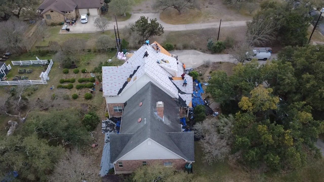 Acacia Roofing crew installing new shingles on Austin area home