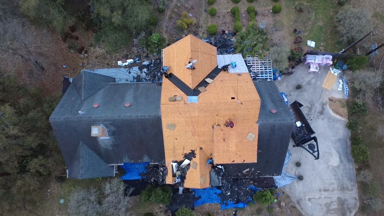 Roof tear-off and full replacement in progress - Central Texas aerial photo